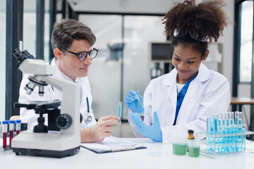 Medical science and microscope in laboratory for research concept. Two scientist with microscope Work in the lab.