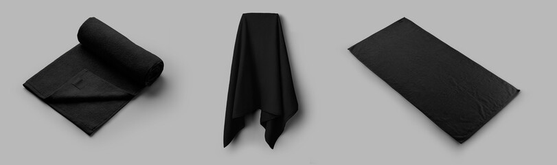 Mockup of a black terry towel on a hanger, rolled, unfolded, isolated on a white background.