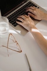 Closeup view of cozy female home office workspace with aesthetic sunlight shadows and glares on...