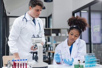 Medical science and microscope in laboratory for research concept. Two scientist with microscope...