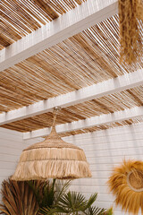 Furniture made of dried palm leaves, straw, rattan. Aesthetic bohemian interior with straw thatch...
