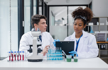 Medical science and microscope in laboratory for research concept. Two scientist with microscope...
