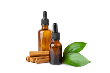 Cinnamon aromatic essential oil and cinnamon sticks isolated on white background. Aromatherapy. Organic cosmetic oil. Spa concept.
