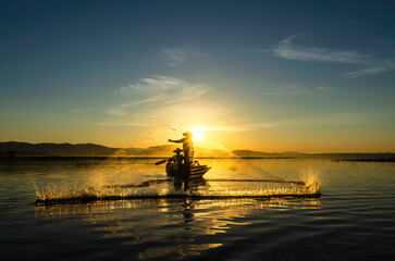 Fisherman of Bangpra Lake in action when fishing, Thailand