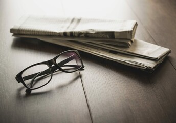 Newspaper reading glasses business desk business newspaper background