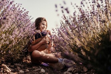 Girl is sitting in a field of purple flowers. She is holding a basket of flowers and smiling. Scene...