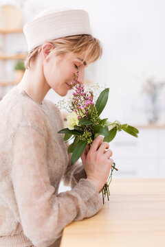 Woman smelling at flower bouquet
