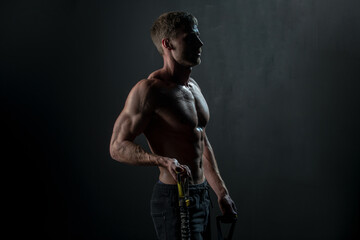 Man exercising suspension training trx. Sexy muscular man doing suspension training. Sport. Men...