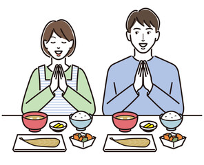 いただきますをする夫婦と和食