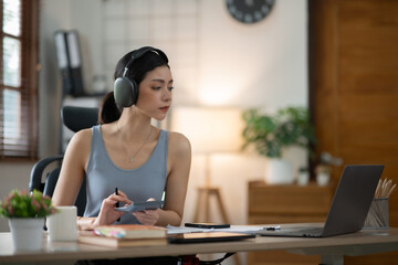 ฺAsia Businesswoman sitting and working using laptop to chat with customers online in office