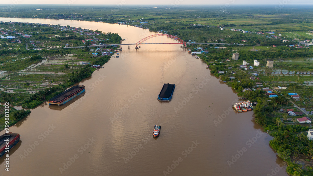 Canvas Prints aerial view of a coal barge passing through a South Kalimantan river