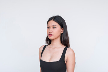 Elegant young Asian woman in black bodysuit against white background