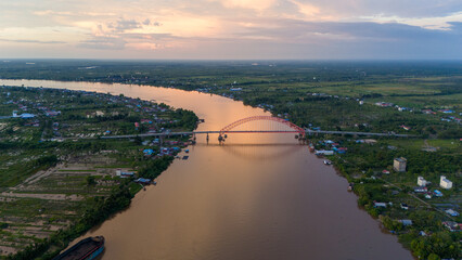 Obraz premium Rumpiang Bridge in the afternoon, a bridge that stretches over the Barito river, Marabahan city, Barito Kuala district, South Kalimantan