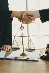 A lawyer prepares for a meeting at their desk, gathering documents and notes. They discuss legal...