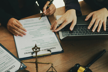 A lawyer prepares for a meeting at their desk, gathering documents and notes. They discuss legal...