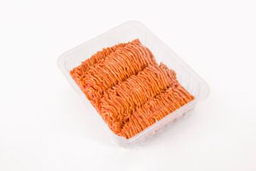 Ready minced meat in a store-bought plastic container isolated on a white background. Close-up.