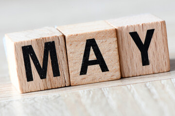 MAY word composed of wooden letters.