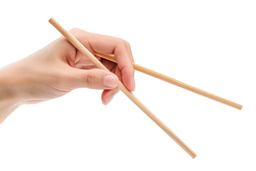 A hand holding wooden chopsticks isolated on a plain background