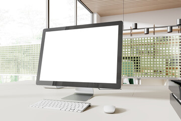 Stylish office interior with pc computer mockup screen on table and window