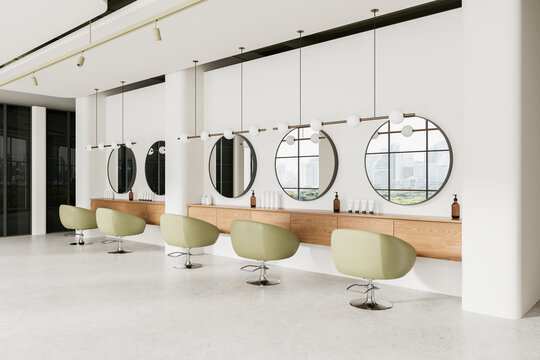 Elegant beauty salon interior with armchairs and round mirrors, panoramic window