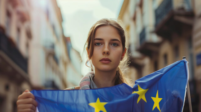 Woman holds the European Union flag in her hand. EU flag at a demonstration for EU accession
