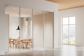 A spacious modern office interior with minimalist wooden furniture and large windows showcasing mountain view, in a bright space. 3D Rendering