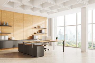 Stylish office interior with work desk and laptop, shelf with panoramic window