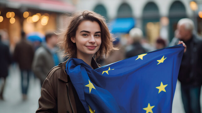 Woman holds the European Union flag in her hand. EU flag at a demonstration for EU accession