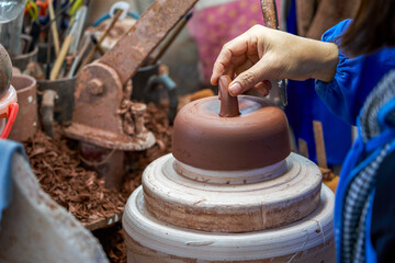 A craftsman makes porcelain in a traditional Chinese porcelain factory