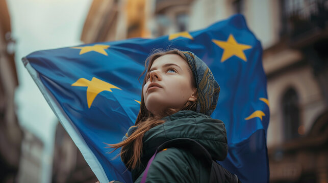 Woman holds the European Union flag in her hand. EU flag at a demonstration for EU accession
