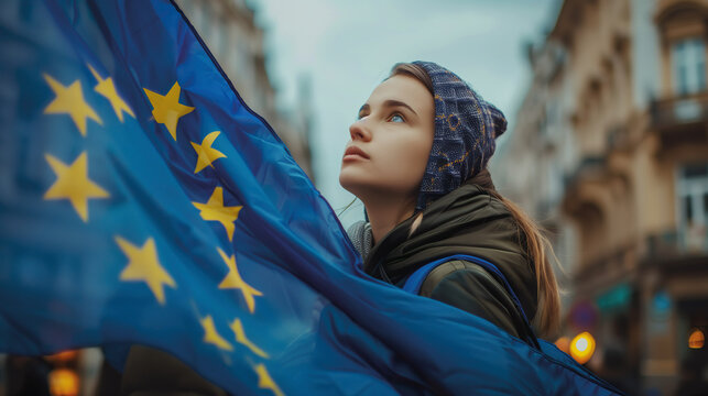 Woman holds the European Union flag in her hand. EU flag at a demonstration for EU accession