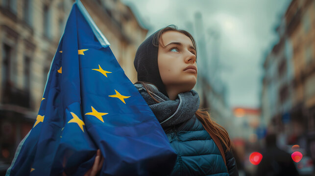 Woman holds the European Union flag in her hand. EU flag at a demonstration for EU accession