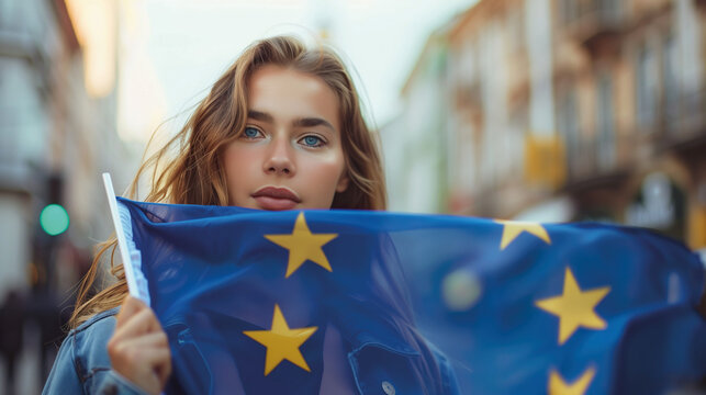 Woman holds the European Union flag in her hand. EU flag at a demonstration for EU accession