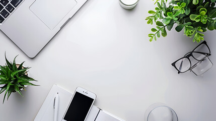  modern designer workplace with copy space, laptop, smartphone and office supplies on white table background,Overhead shot of laptop and business accessories on white background with copyspace