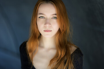 Portrait of beautiful young woman with red hair.