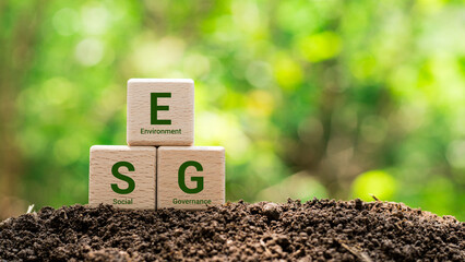 wooden cubes with icon ESG, environment social governance investment business concept and...