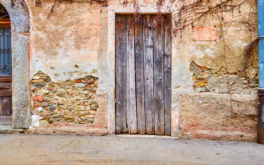 Old wooden door and shabby wall in Savosa village, Switzerland