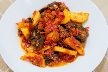 Selective focus of dendeng balado, a traditional cuisine from West Sumatera, Indonesia. It is made from slice of beef with spicy sauce called sambal.