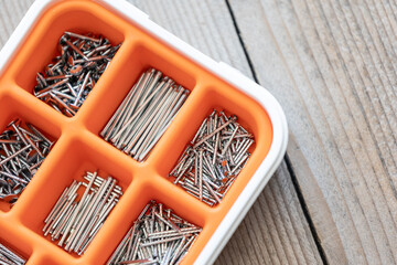 Collection of nails, screws and bolts in plastic box