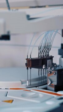 Modern medical equipment is working in the laboratory room at hospital. Work process of automated machine, blood and urine sample analysis in medical clinic. Vertical video