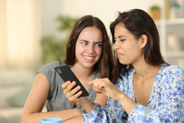 Disgusted women watching nasty content on phone