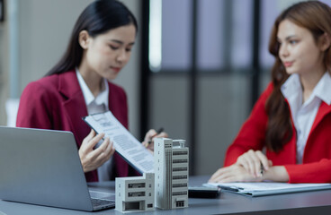 Businesswoman working with housing project to buy and real estate sales. 