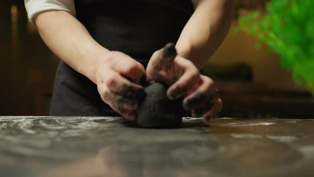 Hands Of Chef Professional Working At Black Dough With Flour And Cuttlefish Ink