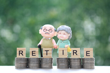 Mutual fund,Love couple senior on stack of coins money on natural green background, Save money for...