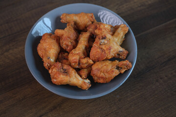 Delicious fresh crispy chicken on a dark wood background. Unhealthy food, fast food