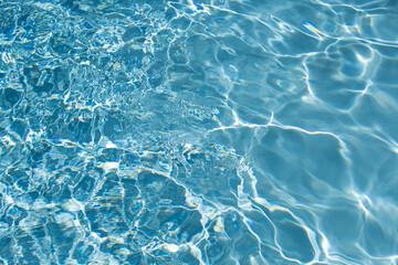 Ripped water in swimming pool. Surface of blue swimming pool, background of water.