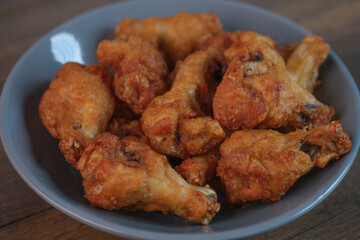 Delicious fresh crispy chicken on a dark wood background. Unhealthy food, fast food