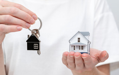 realtor girl with keys to a new house in her hands