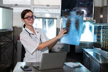 Doctor woman looking check up x-ray film in medical laboratory at hospital. Anatomy diagnostic...