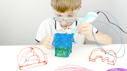 boy drawing with a 3D pen